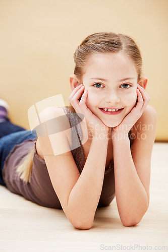 Image of Child, portrait and smile in studio for fashion confidence on brown background as mockup space, innocence or relax. Female person, model and face of young student for positive mood, cute or style