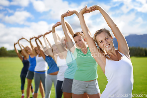 Image of Women stretching arms, exercise and outdoor for team sports field and fitness class. Health, portrait and training together, young athlete group workout in park and physical activity with warm up