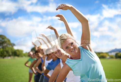 Image of Women stretching, team outdoor and exercise on sports field, fitness class and physical activity. Health, portrait and training together, young athlete group workout in park and warm up with wellness