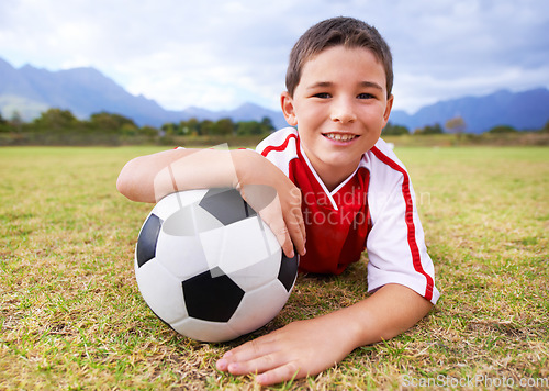 Image of Boy, soccer player and ball with portrait, happy and ready for game, field and child. Outdoor, playful and sport for childhood, uniform and athlete for match, alone and outside on football pitch