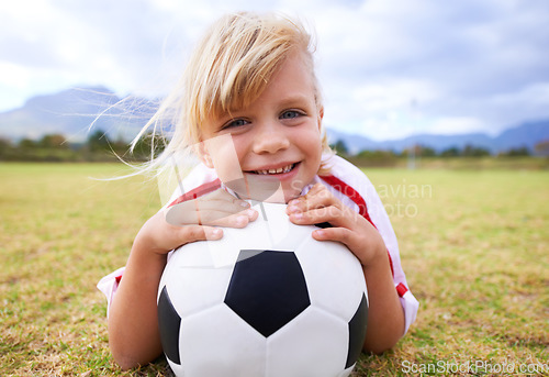 Image of Child, soccer player and ball with portrait, smile and ready for game, field and girl. Outdoor, playful and sport for childhood, happy and athlete for match, alone and outside on football pitch