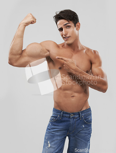 Image of Man, portrait and biceps or bodybuilder pride in studio, wellness and fitness by gray background. Male person, arms and strong or muscular abdomen, confident and results or progress from exercise