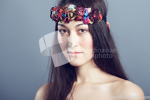 Image of Woman, portrait and flower headband in hair with beauty, skin glow and wellness on grey background. Face, hairstyle with floral head gear or accessory, dermatology and cosmetics to blossom in studio