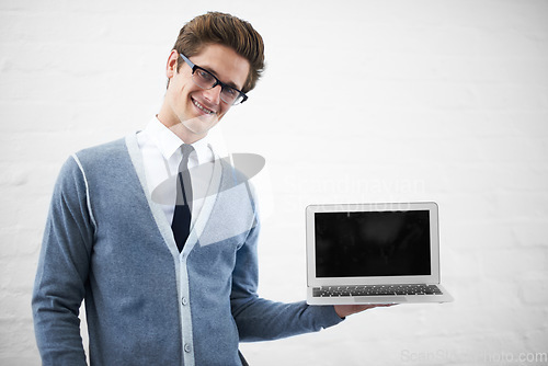 Image of Happy man, portrait and laptop screen for advertising or marketing on a gray studio background. Male person, nerd or geek smile with computer, tech display or mockup space for advertisement, UI or UX