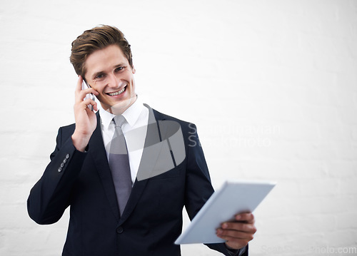 Image of Business man, phone call and tablet by wall, portrait and contact for networking by white background. Entrepreneur, employee or person with touchscreen, smartphone and mockup space for negotiation