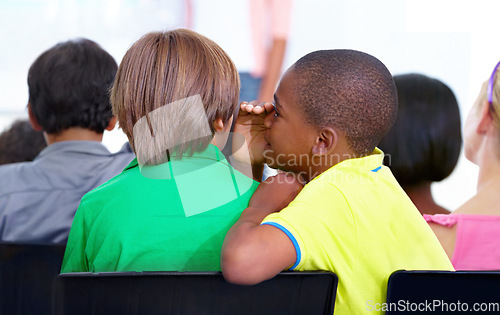 Image of Little boys, whisper and classroom in ear for secret, gossip or communication at school. Male person, students or friends listening to rumor, information or surprise in class together with teacher