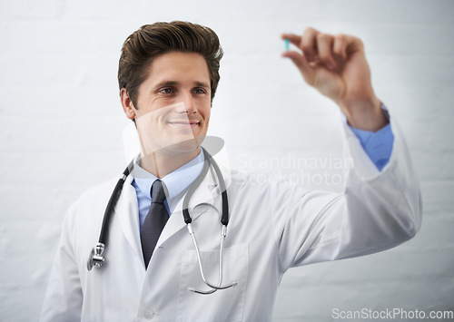 Image of Happy man, doctor and checking pill for healthcare, cure or drugs on a white studio background or wall. Male person, surgeon or medical nurse looking at medication in research, study or examination