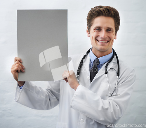 Image of Happy man, portrait and doctor with poster in healthcare, advertising or marketing on a white studio background. Male person, nurse or medical surgeon smile with banner, blank sign or mockup space