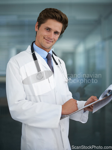 Image of Clipboard, happy and portrait of doctor in his office for diagnosis or treatment at medical hospital. Checklist, career and professional young male healthcare worker reading in medicare clinic.