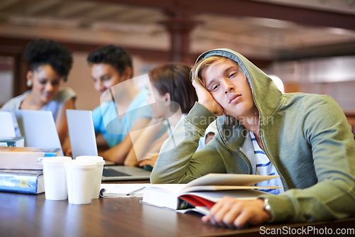 Image of Tired, study group or portrait of student in library with burnout, depression or low energy. Lazy man, university or exhausted person bored by books with fatigue or adhd with people for teamwork