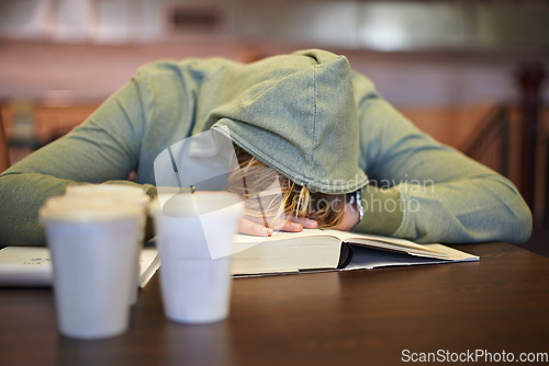 Image of Tired, student or sleeping in library with burnout, stress depression or low energy for deadline. Fatigue, university or exhausted person with books, coffee or head down in nap on table for resting