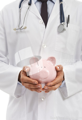 Image of Doctor, man and piggy bank for savings in studio, investment and financial loan for healthcare. Male professional, funding and planning hospital budget by white background, profit and future security