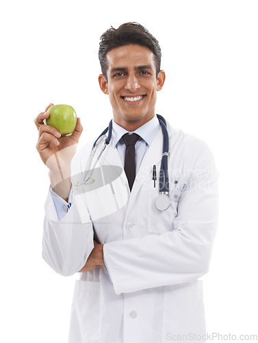 Image of Doctor, portrait and man smile with apple in studio, nutrition and healthy diet or fiber in fruit. Male medical professional, healthcare and promotion of organic snack, face and white background