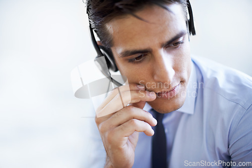 Image of Call center, man and communication in studio of customer service, CRM questions and help on white background. Face, serious telemarketing agent and thinking of telecom advisory, microphone and mockup