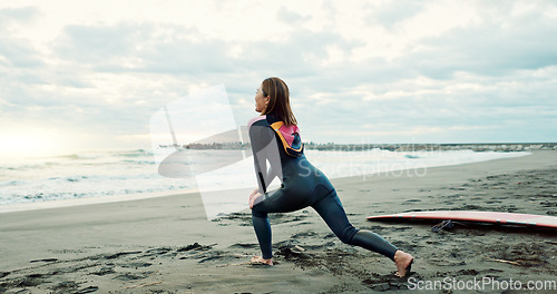 Image of Surfer, woman stretching at beach and back, fitness for extreme sports with ocean, waves and travel. Flexibility, warm up and exercise outdoor, surf and nature with surfboard and athlete on adventure