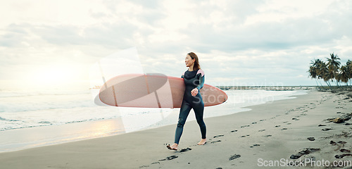 Image of Woman, surfing board and walking on sand at beach, sea and ocean for summer holiday, travel adventure and happiness. Japanese surfer on shore for water sports, freedom and relax for tropical vacation