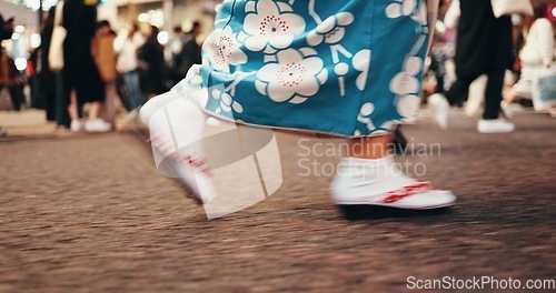 Image of Japanese woman, feet and walking in kimono in city, journey and wellness for heritage on road. Person, blur or traditional clothes in tokyo street on holiday or sandals for travel in japan fashion
