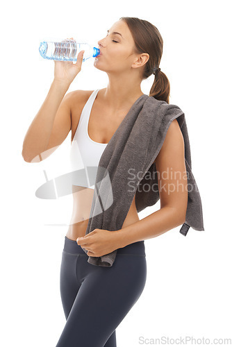 Image of Woman, towel and drinking water in studio for exercise recovery, energy and healthy detox on white background. Thirsty model, fitness and bottle for sports nutrition, weight loss diet and hydration