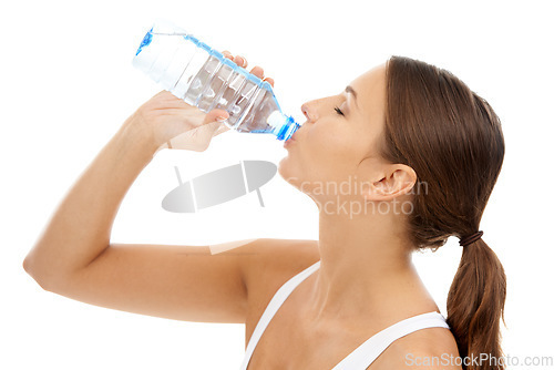 Image of Fitness, woman and drinking water in studio for exercise break, energy and healthy detox on white background. Thirsty model, liquid hydration and bottle for sports nutrition, weight loss diet or care