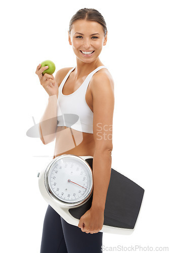 Image of Studio portrait, apple or happy woman with scale to track weight loss progress, nutrition or body goals. Fruit, vegan lifestyle or nutritionist smile for slimming, diet or fitness on white background