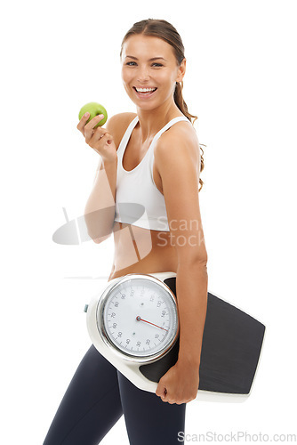 Image of Portrait, happiness or woman with apple, scale and smile for weight loss, nutrition or body goals. Studio, healthy lifestyle or model happy for fruit benefit, diet food or fitness on white background