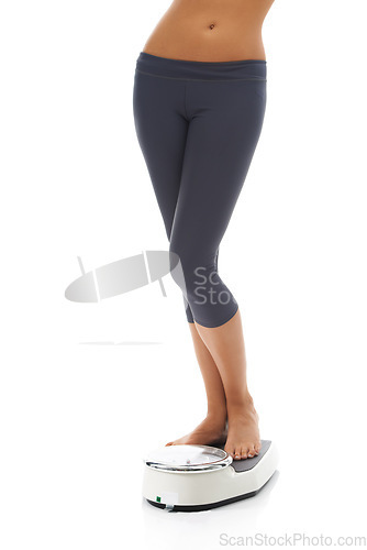 Image of Studio, legs and person with scale for weight loss progress, fitness or to track body transformation, change or slimming goals. Machine, feet and model check for BMI, diet or mass on white background