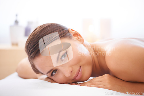 Image of Relax, portrait and young woman at spa with body massage for health, wellness and self care. Smile, natural and female person with calm, peaceful and serene skin therapy treatment at beauty salon.