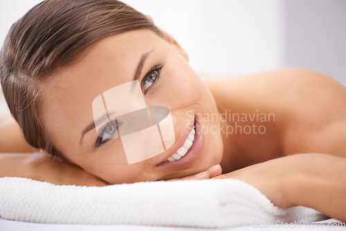 Image of Relax, smile and young woman at spa with body massage for health, wellness and self care. Happy, natural and female person with calm, peaceful and serene skin therapy treatment at beauty salon.