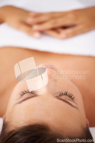 Image of Woman, face and massage at spa, skin and treatment for wellness, zen and beauty with stress relief and self care. Relax, bodycare and health with holistic healing, calm and peace at luxury resort