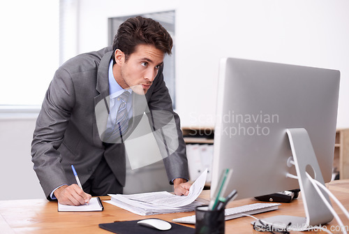 Image of Business man, writing notes and computer for planning, reading report and planning and documents review. Accountant or auditor with notebook, bookkeeping paperwork and priority or list in his office