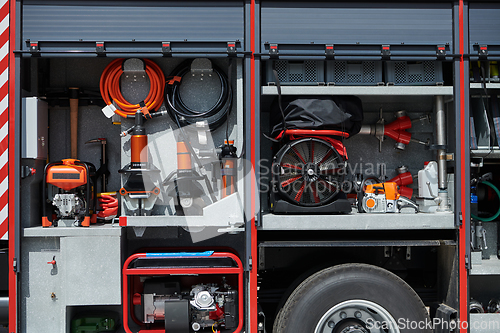 Image of Close-up of essential firefighting equipment on a modern firetruck, showcasing tools and gear ready for emergency response to hazardous fire situations