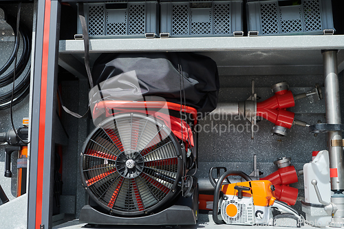 Image of Close-up of essential firefighting equipment on a modern firetruck, showcasing tools and gear ready for emergency response to hazardous fire situations