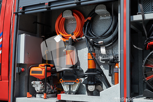 Image of Close-up of essential firefighting equipment on a modern firetruck, showcasing tools and gear ready for emergency response to hazardous fire situations