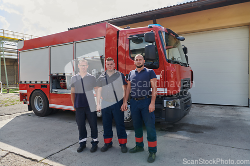 Image of A skilled and dedicated professional firefighting team proudly poses in front of their state of the art firetruck, showcasing their modern equipment and commitment to ensuring public safety.