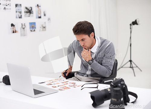 Image of Photographer, editing and thinking with computer in office with working with technology in process. Professional, editor and creative person with laptop and photoshoot results of cinematography