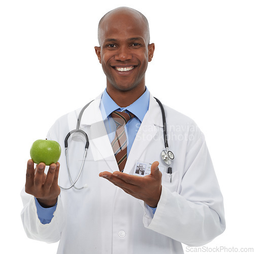 Image of Portrait, doctor and happy black man with apple for fruit diet, healthcare nutrition or vitamin c benefits. Studio, vegan food and African nurse smile for health recommendation on white background