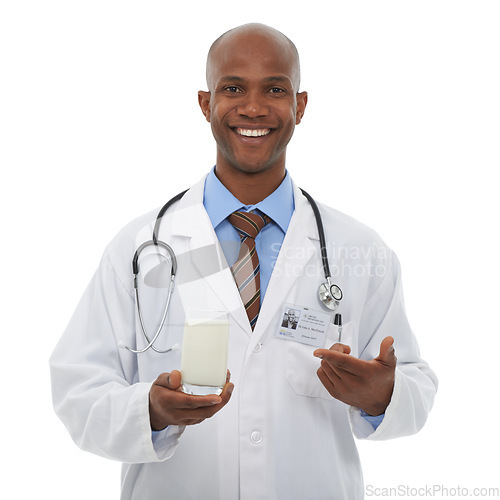 Image of Portrait, black man and happy doctor point at milk for healthy bones, studio nutrition or calcium benefits. Beverage glass, hydration drink or African dietician with dairy product on white background