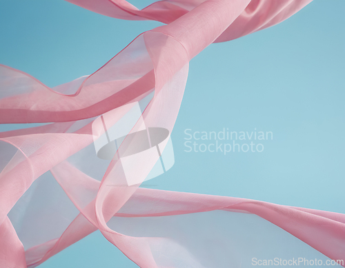 Image of Flying pink fabric wave on blue background, flowing waving silk 