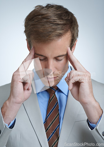 Image of Businessman, headache and burnout in studio for job, mental health and bankrupt or stress. Male person, migraine and frustrated by white background, deadline and depression or mistake and tension