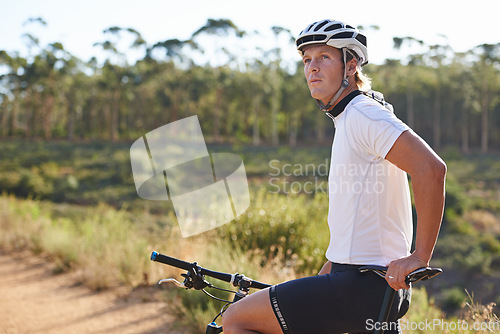 Image of Man, cyclist and thinking on mountain bicycle, training and energy for rider, cycling and sport. Outdoor, hobby and fitness in nature, trail and active for wellness, helmet and physical workout