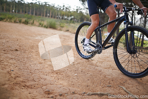 Image of Person, legs and mountain bike for cycling fitness on nature path for health challenge, performance or extreme sport. Athlete, exercise and off road dirt terrain or adventure, wellness or competition