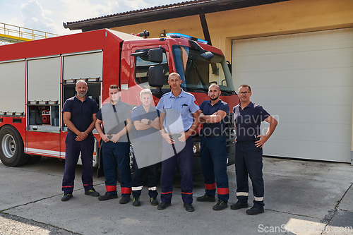 Image of A skilled and dedicated professional firefighting team proudly poses in front of their state of the art firetruck, showcasing their modern equipment and commitment to ensuring public safety.