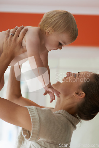 Image of Baby, mother and playing in home for wellness with nurture, relationship and bonding for happiness. Family, child or toddler and embrace with early childhood, parenting and smile in living room