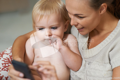 Image of Mother, baby and phone or smile with internet for social media, video streaming or cartoons for development. Family, woman and toddler or child with smartphone for scroll, search and entertainment