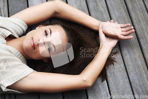 Image of Woman, face and happy on porch for relax outdoor in backyard with break, lying down and rest in home. Person, portrait and smile on wooden deck in garden of house or apartment with carefree or casual