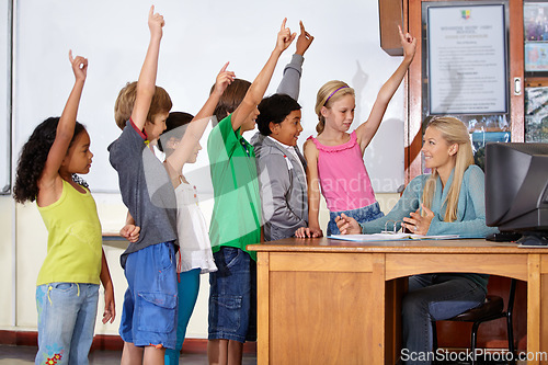 Image of Teacher woman, classroom and children with raised hand for question, answer or pop quiz for knowledge. Teaching person, school kids and education for development, scholarship or assessment at academy