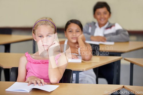 Image of Tired, children and bored of learning, education and books from adhd, burnout and frustrated with work in school. Exhausted, girl or thinking of studying, group and problem with mindset in classroom