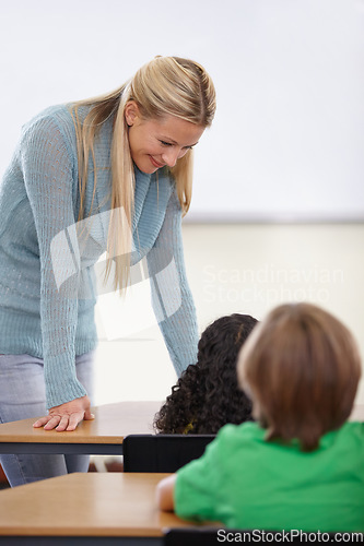 Image of Teacher, children and students in classroom for education, learning and language development or support at desk. Happy woman with kids for teaching, helping with knowledge and questions at school