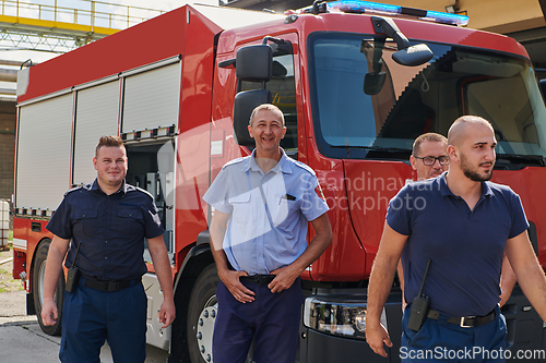 Image of A skilled and dedicated professional firefighting team proudly poses in front of their state of the art firetruck, showcasing their modern equipment and commitment to ensuring public safety.