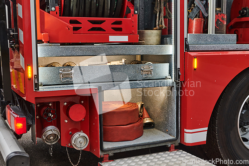Image of Close-up of essential firefighting equipment on a modern firetruck, showcasing tools and gear ready for emergency response to hazardous fire situations
